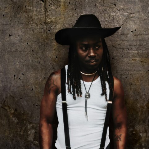 a man wearing a hat and suspenders