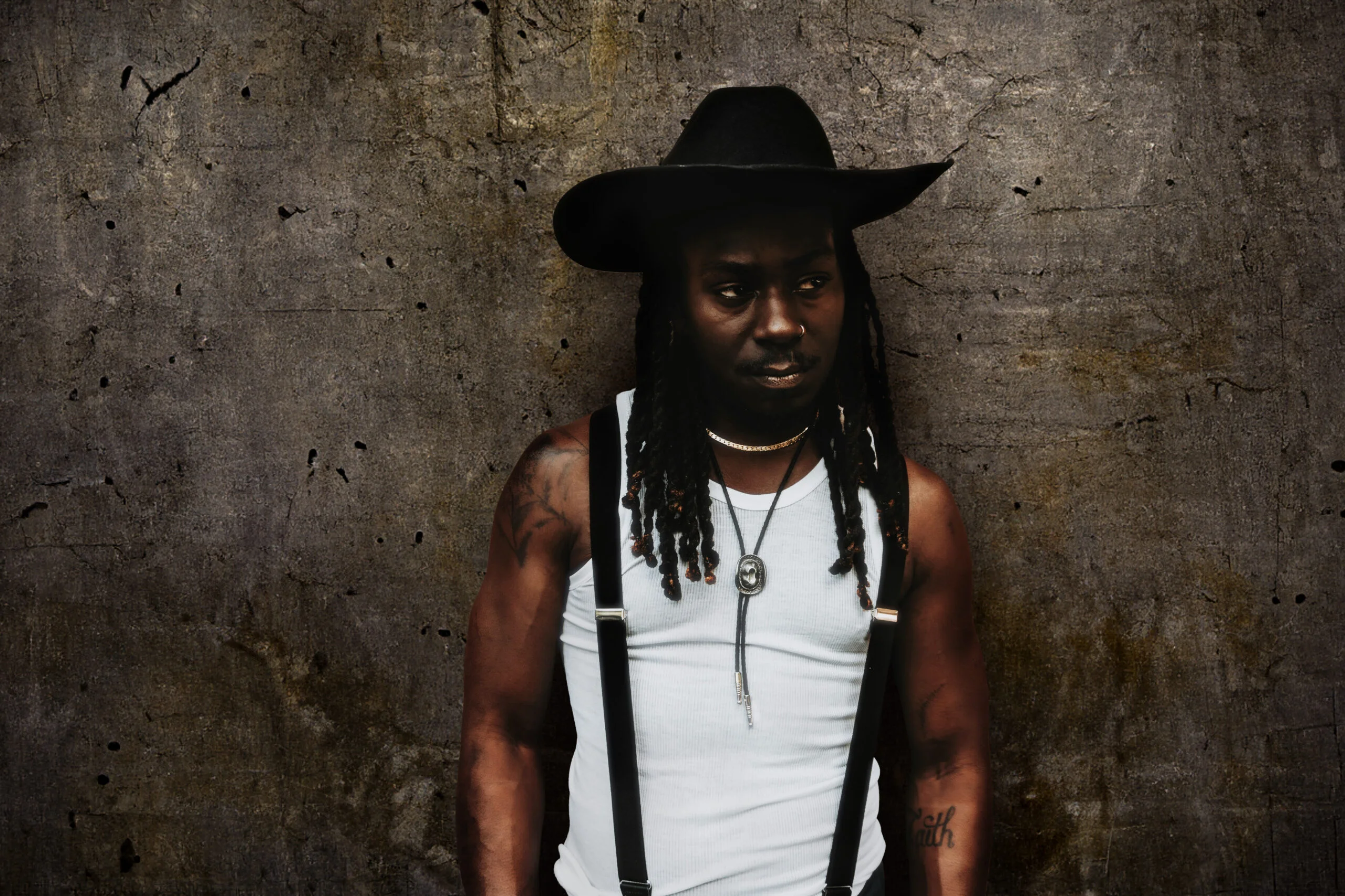 a man wearing a hat and suspenders