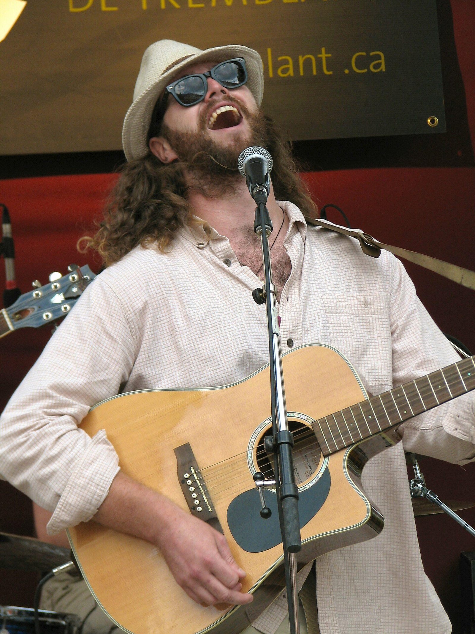 man in white dress shirt playing guitar